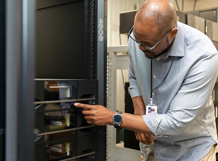 Franck Mpinda working in the UKCEH server room in Wallingford