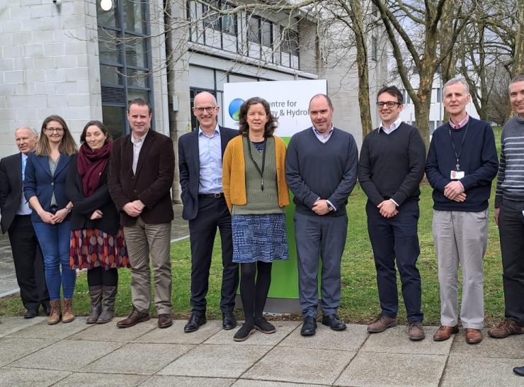 Group of 12 people from UKCEH and Met Office standing outside UKCEH offices