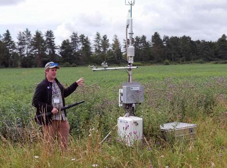 Ross Morrison from UKCEH beside a flux tower that measures site-level greenhouse gas emissions 
