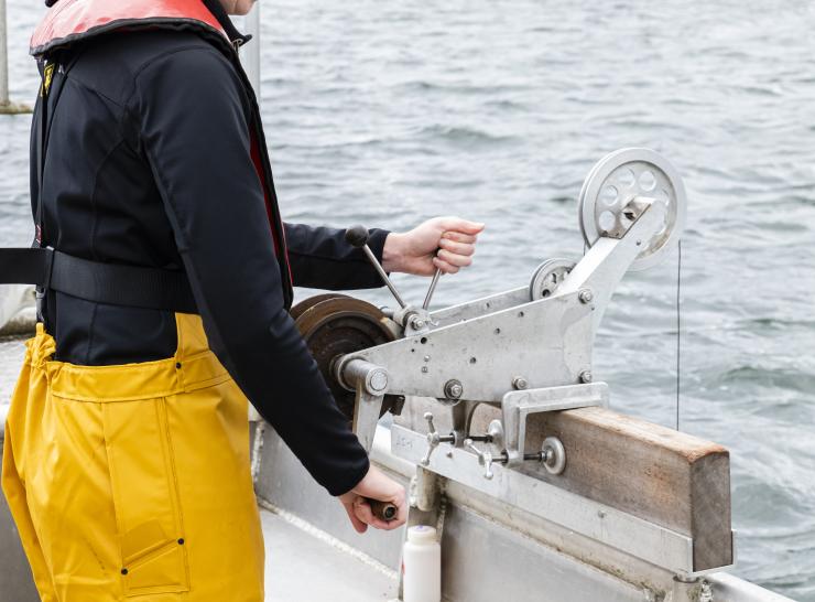 Field scientist on a boat taking samples