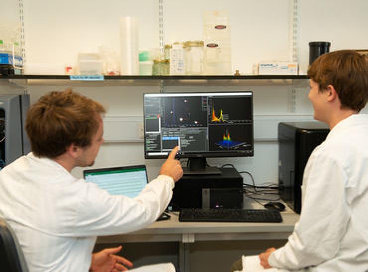 Male and female scientists analysing scientific results on computer screen