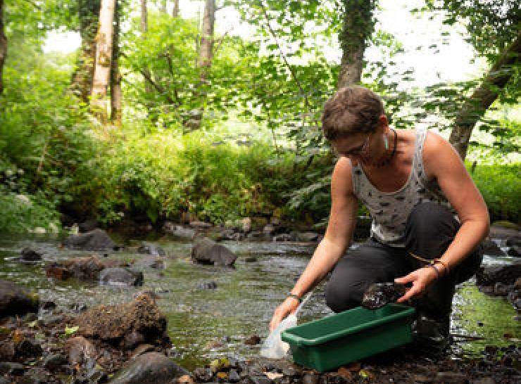 Female scientist sampling freshwater