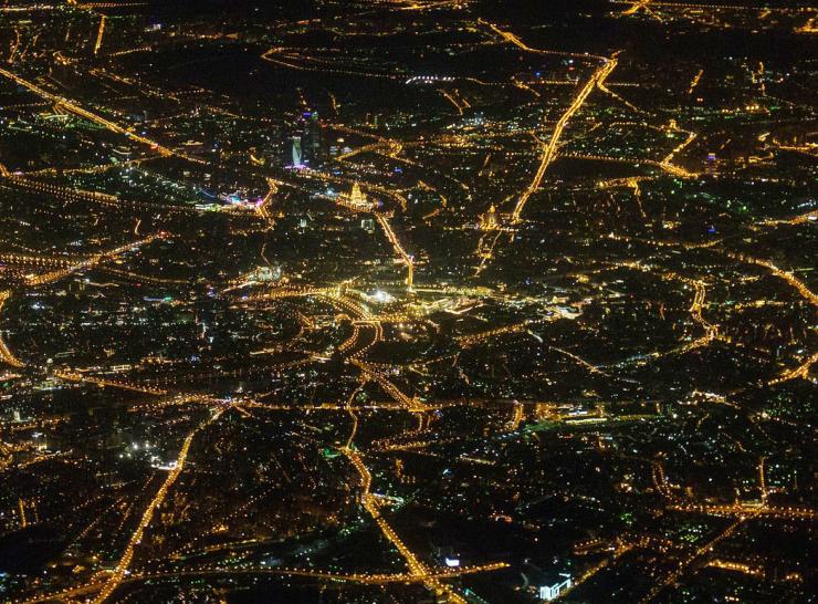 Aerial view of city at night showing streetlighting