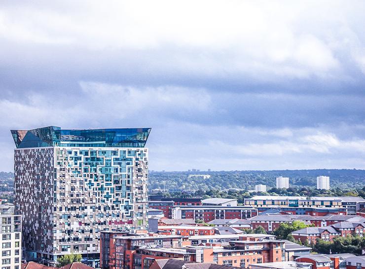 View over Birmingham city skyline with lots of trees