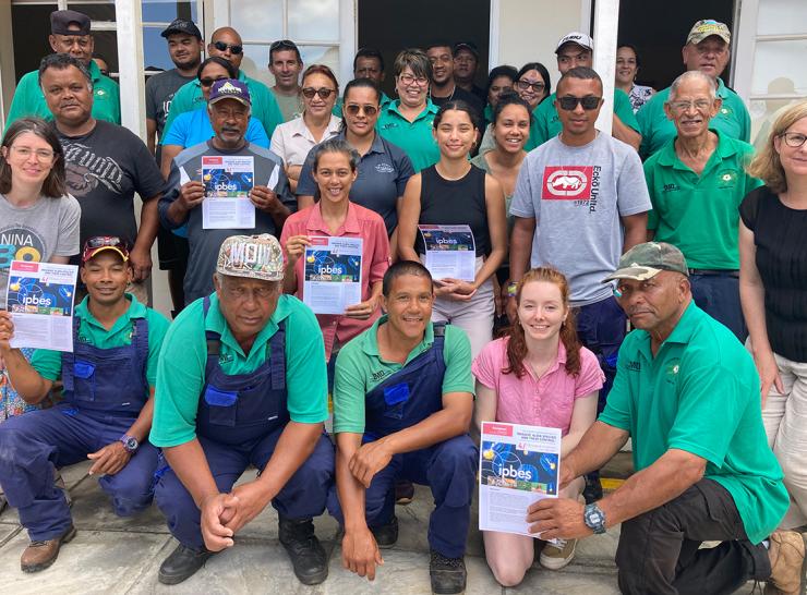 Invasive non-native species workshop participants on St Helena hold copies of the IPBES biological invasions on islands factsheet