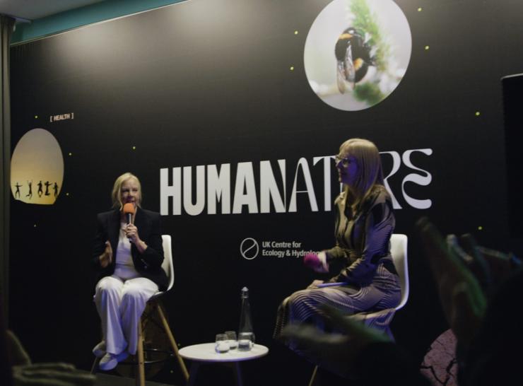 Two people talking on a stage