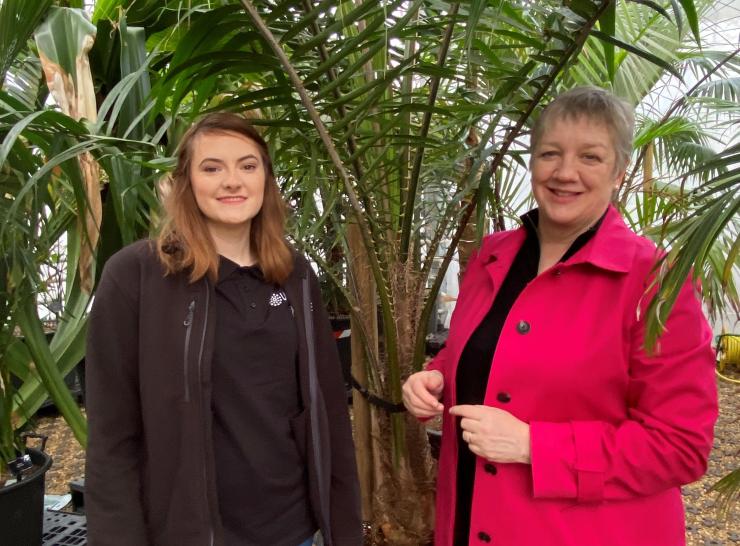 Two people stood in front of a tree