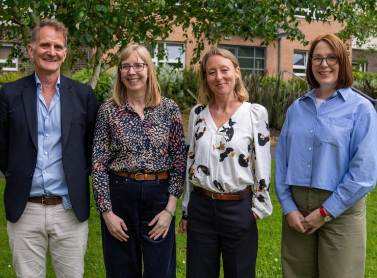 Four people standing in front of the camera