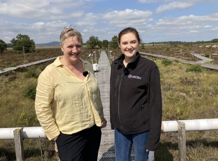Two women stood on a field site