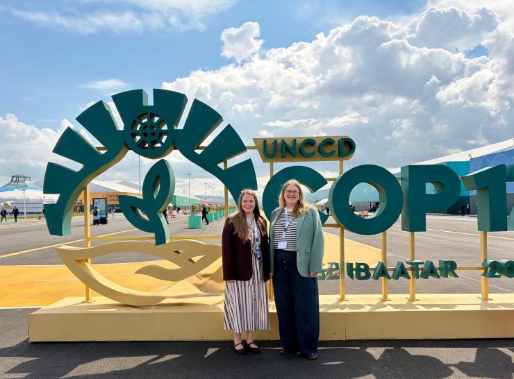 Two women in front of COP17 sign