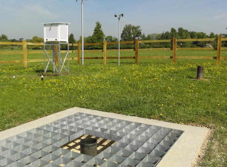 A ground level rain gauge in the foreground and a  Stevenson screen in the background at CEH's met station in Wallingford, Oxfordshire.  Photo: Harry Dixon/Centre for Ecology & Hydrology