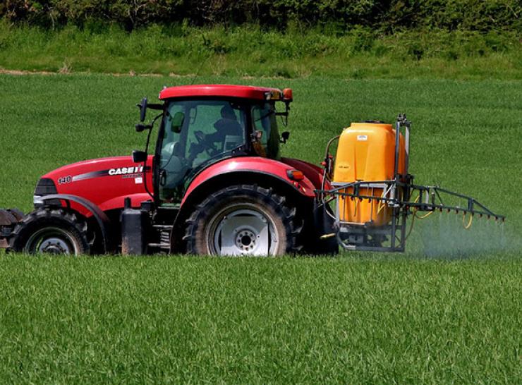 Tractor spraying insecticide